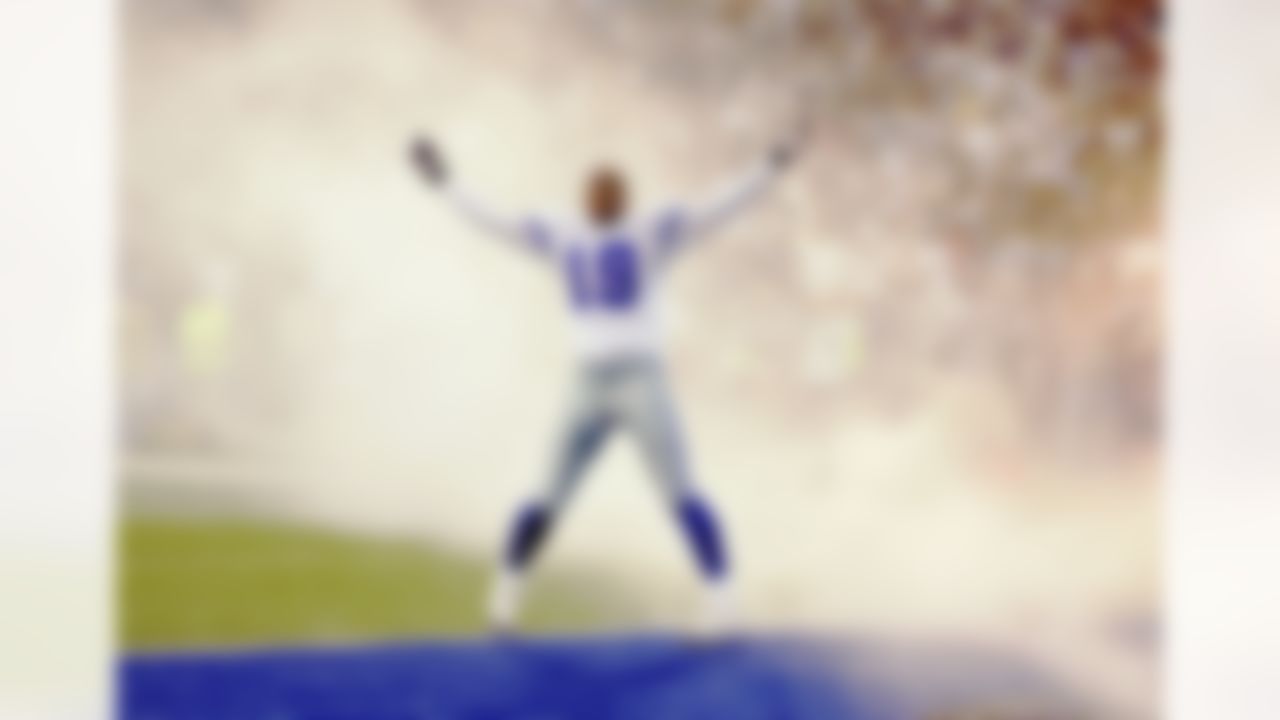 Wide receiver Keyshawn Johnson #19 of the Dallas Cowboys acknowledges the crowd by throwing up his arms amidst the smoke during pregame introductions against the Philadelphia Eagles at Texas Stadium on November 15, 2004 in Irving, Texas. The Eagles defeated the Cowboys 49-21.