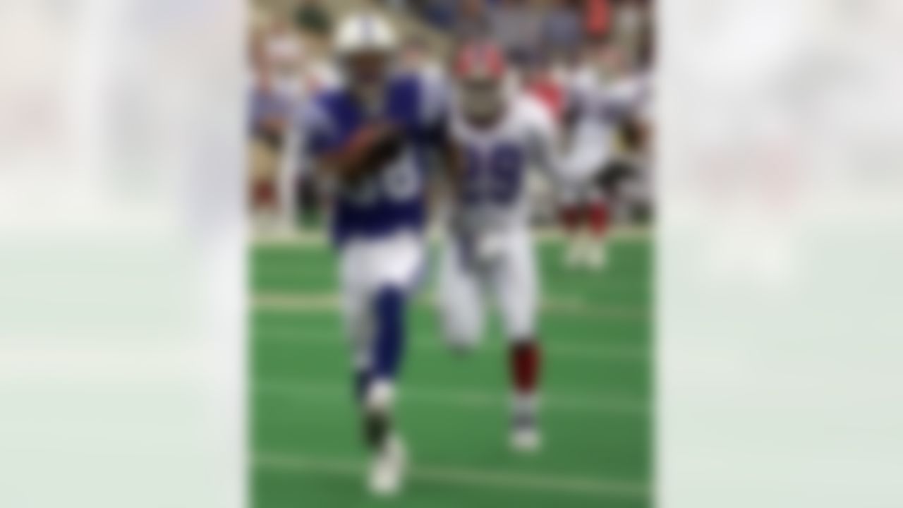 Indianapolis Colts receiver Marvin Harrison, left, high steps his way into the end zone for his second touchdown after beating out Buffalo Bills defensive back Keion Carpenter in the second quarter Sunday, Sept. 23, 2001, in Indianapolis. Harrison scored on a 39-yard pass from Peyton Manning. (AP Photo/Michael Conroy)