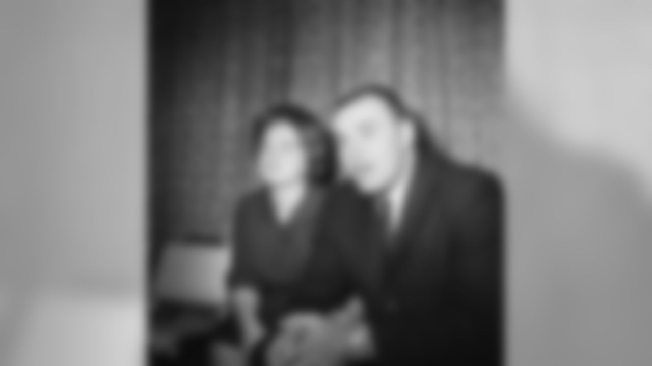 Linebacker Dick Butkus, called the collegian most coveted by pro football in recent years, is shown with his wife, Helen, during signing ceremonies by the Chicago Bears of the NFL, Dec. 3, 1964. Butkus as a 245-pound linebacker was a University of Illinois standout. (Harry L. Hall\Associated Press)