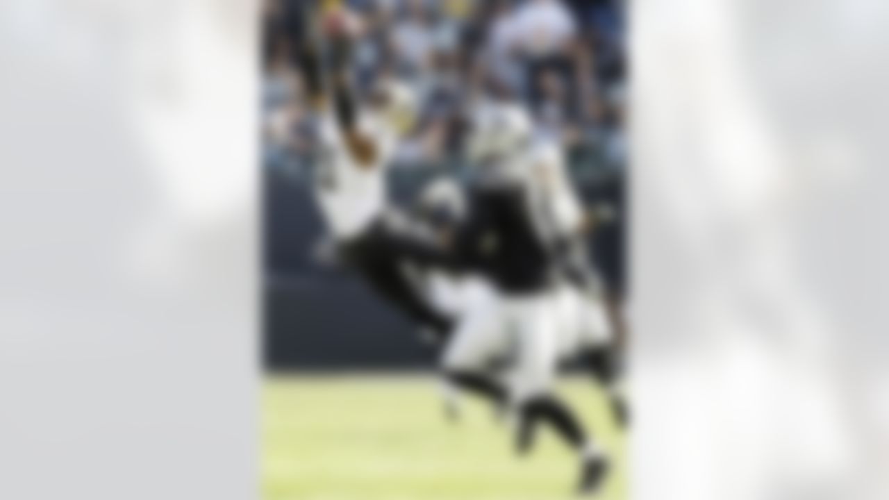 New Orleans Saints cornerback Patrick Robinson leaps and misses a pass intended for Oakland Raiders wide receiver Derek Hagan during the first quarter of an NFL football game in Oakland, Calif., Sunday, Nov. 18, 2012. (AP Photo/Marcio Jose Sanchez)