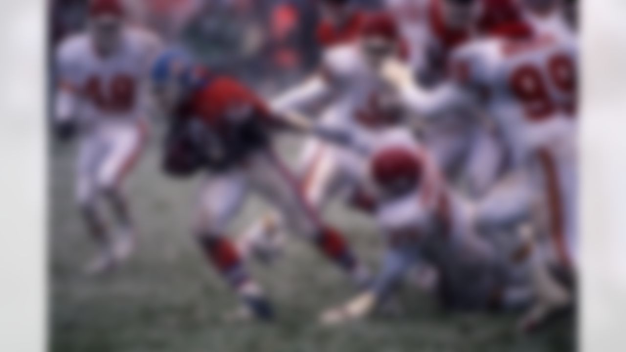 Denver Broncos running back Terrell Davis (30) runs upfield during an NFL game in a snowstorm, against the Kansas City Chiefs in Denver, Oct. 22, 1995. The Chiefs defeated the Broncos 21-7. (AP Photo/Eric Lars Bakke)
