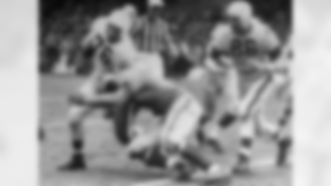 Cleveland Browns fullback Marion Motley (76) picks up 12 yards and a first down in the fourth period against the Los Angeles Rams during the championship, at Cleveland, Ohio, Dec. 24, 1950. Rams' halfback Paul Younger tackles Motley as Cleveland halfback Dub Jones (86), comes up too late to put a block on the tackler. Browns took the title by beating the Rams 30-28 on Lou Groza's field goal in last twenty seconds of play. (Associated Press)