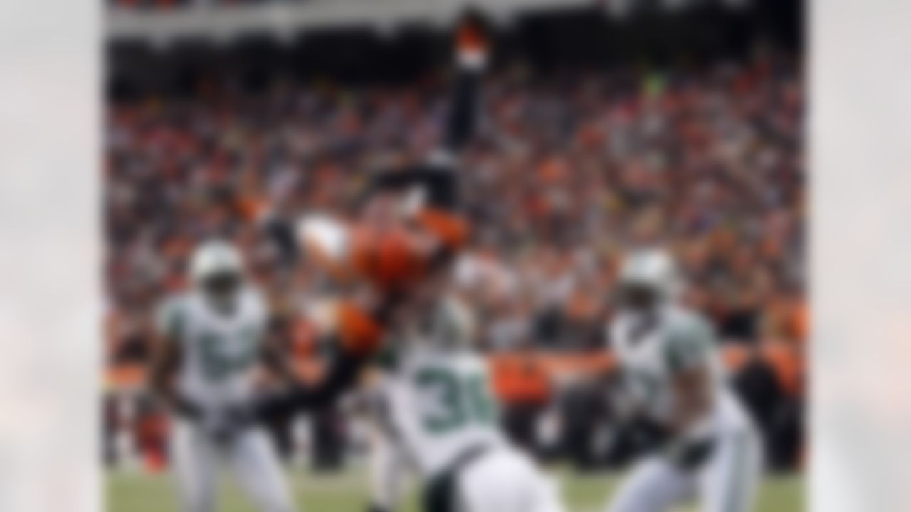 Cincinnati Bengals receiver Andre Caldwell (87) is upended by New York Jets safety Jim Leonhard (36) for an incomplete pass during the first half of an NFL wild-card playoff football game, Saturday, Jan. 9, 2010, in Cincinnati. (AP Photo/Ed Reinke)