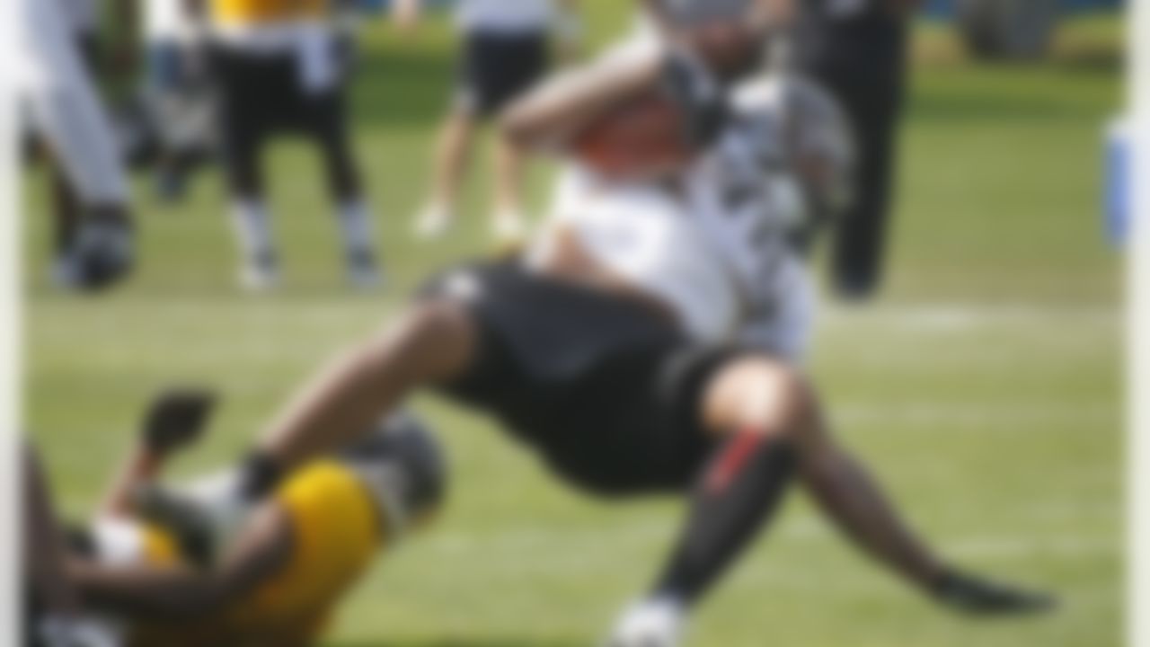 Pittsburgh Steelers running back John Clay (38) tumbles as he tries to spin out of a tackle during practice at the NFL football training camp in Latrobe, Pa. on Saturday, July 28, 2012 . (AP Photo/Keith Srakocic)