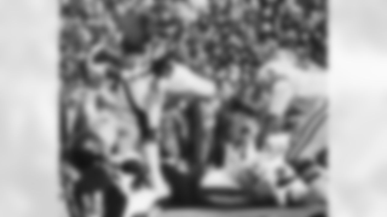 Chicago Bears running back Walter Payton (34) picks his way through the line to pick up four yards in the first quarter against the Green Bay Packers in Chicago, Dec. 11, 1977. He goes over the Bears' Noah Jackson (65) and into the arms of Green Bay's Fred Carr (53). (AP Laser Photo/Larry Stoddard)