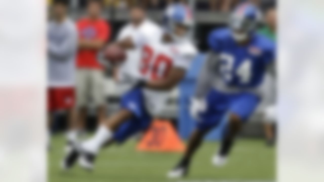 New York Giants cornerback Terell Thomas (24) runs beside wide receiver Victor Cruz (80) on a practice play at the New York Giants NFL football training camp in Albany, N.Y., Saturday, July 28, 2012. (AP Photo/Kathy Willens)