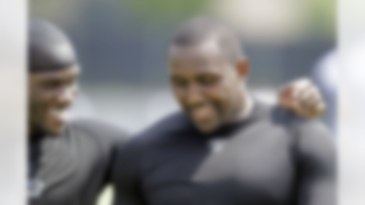 Carolina Panthers' Thomas Davis, right, talks with teammate Jon Beason, left, after a voluntary football workout session in Charlotte, N.C., Wednesday, June 2, 2010. (AP Photo/Chuck Burton)
