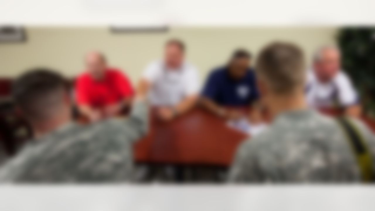 (L-R) Minnesota Vikings head coach Brad Childress, Philadelphia Eagles head coach Andy Reid, Cincinnati Bengals head coach Marvin Lewis, and Carolina Panthers head coach John Fox sign autographs and greet soldiers during a USO/Armed Forces Entertainment tour stop at Baumholder Army Garrison in Germany July 1, 2010. The four in-demand NFL coaches are on their first overseas tour visiting Germany and the Persian Gulf over the course of a week. (Fred Greaves/USO)
