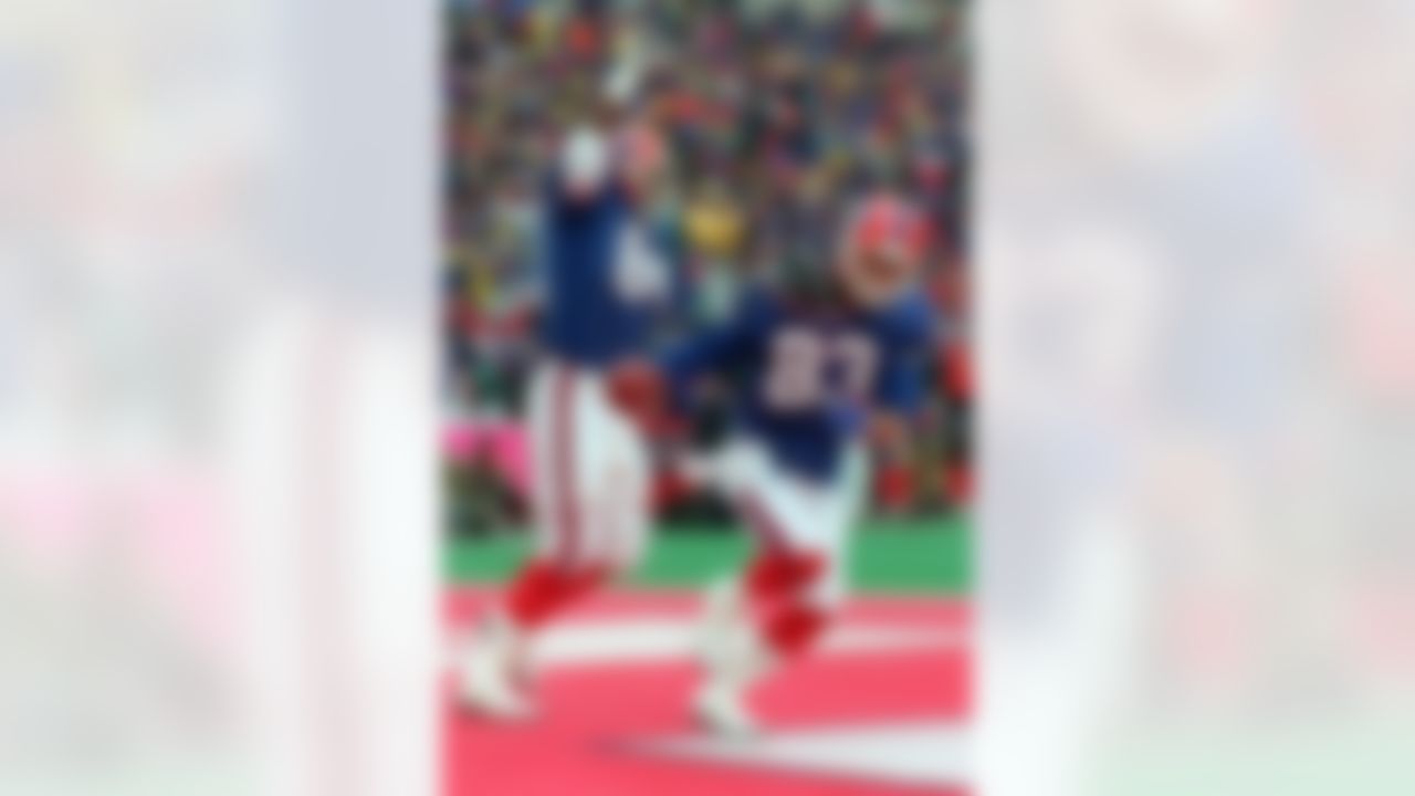 Buffalo Bills wide receiver Andre Reed (83) and Keith McKeller celebrate Reed's third touchdown during the fourth quarter of an NFL football wild-card playoff game against the Houston Oilers at Rich Stadium in Orchard Park, N.Y. The Bills came back from a 35-3 deficit to win 41-38 in overtime. Buffalo's comeback is considered one of the all-time greatest in sports history. (AP Photo/Bill Sikes, File)