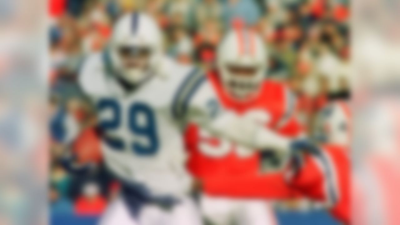 Indianapolis Colts running back Eric Dickerson (29) wards off New England Patriots defenders Andre Tippett (56) and Ronnie Lippett (42) as he gains yardage in this Nov. 22, 1987 photo in Foxboro, Mass. Dickerson, who gained over 13,000 yards in his career, is on the Pro football Hall of Fame ballot for the first time on Saturday. (AP Photo/Elise Amendola)