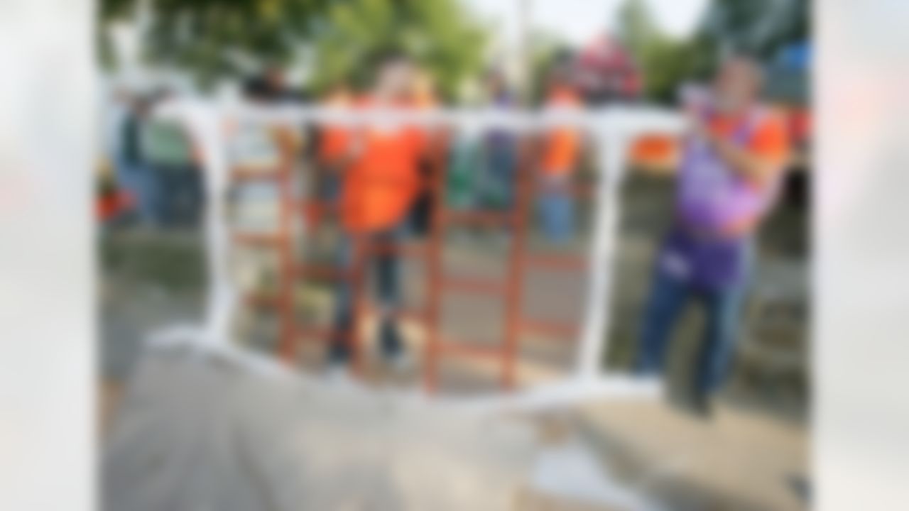 The Home Depot associates unwrapping one of the new playground pieces. (Photo by Alan Marler/CIA Stock Photography, Inc.)