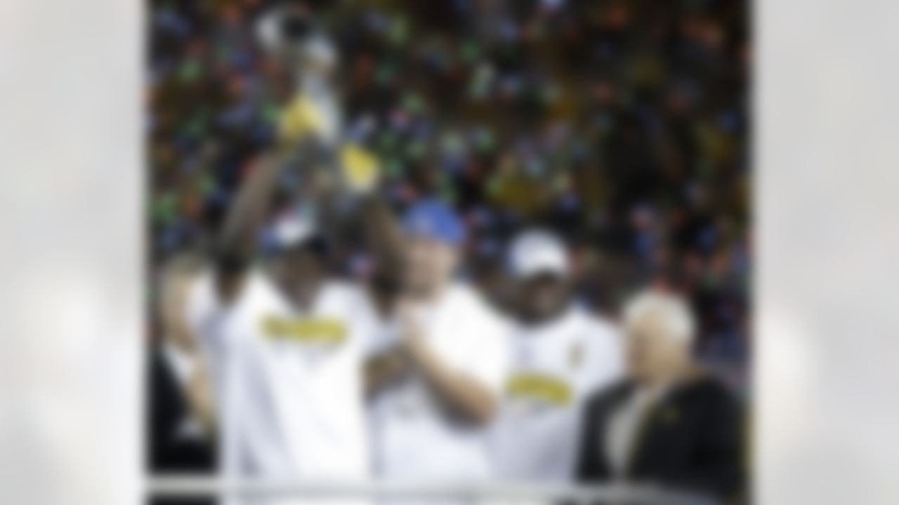 Pittsburgh Steelers wide receiver Santonio Holmes (10) , Pittsburgh Steelers quarterback Ben Roethlisberger (7), Pittsburgh Steelers head coach Mike Tomlin and team owner Daniel M. Rooney celebrate the Pittsburgh Steelers defeating the Arizona Cardinals 27-23 in the NFL Super Bowl XLIII football game, Sunday, Feb. 1, 2009, in Tampa, Fla. (AP Photo/Julie Jacobson)