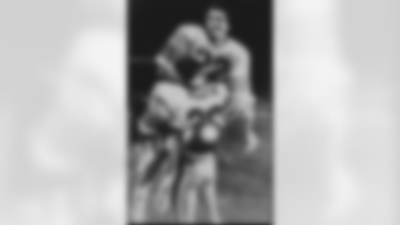 Boston College quarterback Doug Flutie rejoices in his brother Darren's arms after B.C. defeated the Miami Hurricanes with a last second touchdown pass, in Miami, on Nov. 23, 1984. (Associated Press)