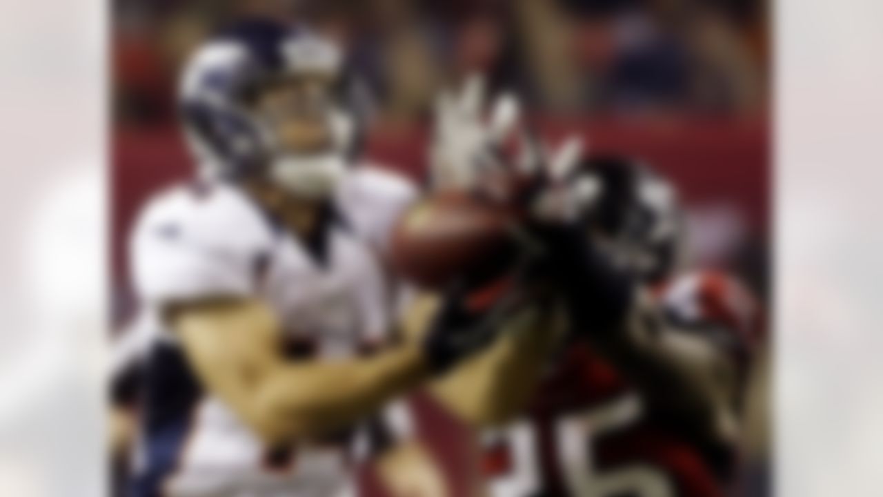 Denver Broncos wide receiver Brandon Stokley (14) makes a catch under the defense of Atlanta Falcons strong safety William Moore (25) during the second half of an NFL football game, Monday, Sept. 17, 2012, in Atlanta. (AP Photo/John Bazemore)