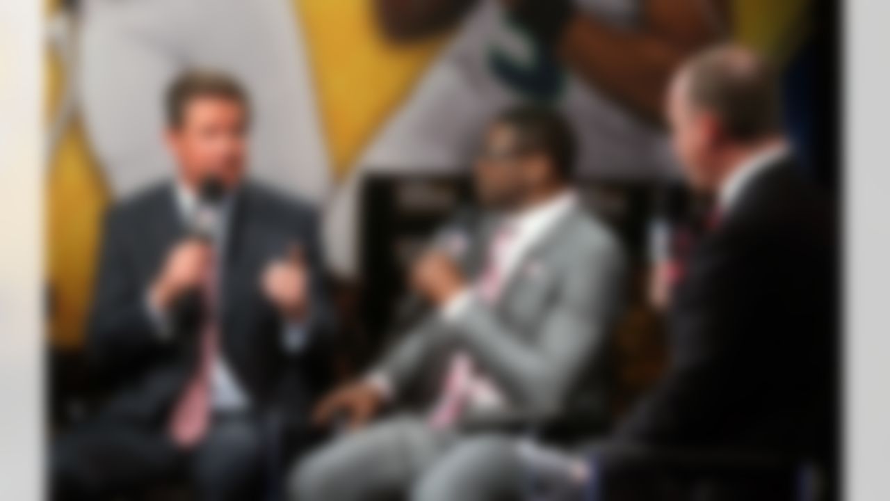 Former Miami Dolphins quarterback and Hall of Famer Dan Marino speaks with Michael Irvin and Rich Eisen on the NFL Network set on Radio Row at the Super Bowl XLVIII media center in the Sheraton Hotel on Wednesday, January 29, 2014 in New York, NY. (Perry Knotts/NFL)