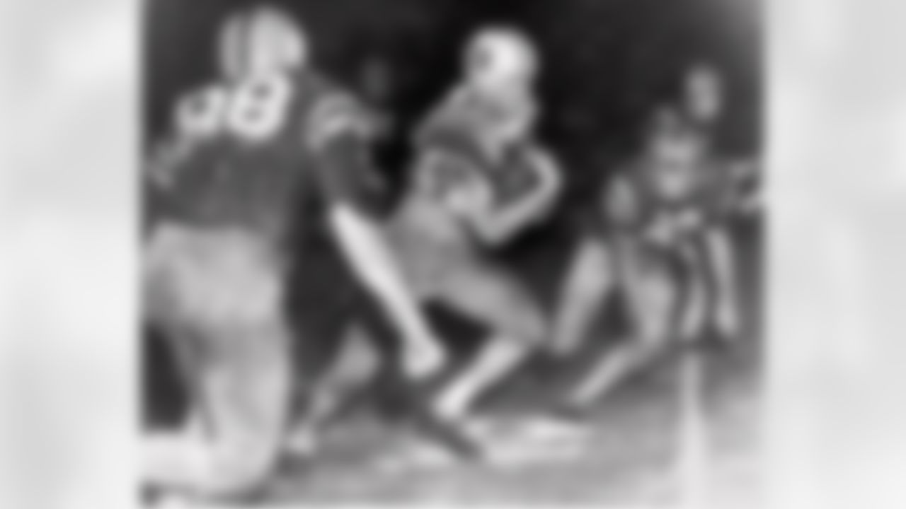 Billy Cannon, Louisiana State University's All-America halfback, slips by tacklers at the start of an 89-yard punt return for a touchdown to help his champion Tigers beat third-ranked Mississippi, 7-3 in a college football game in Baton Rouge, La. on Oct. 31, 1959. (Associated Press)