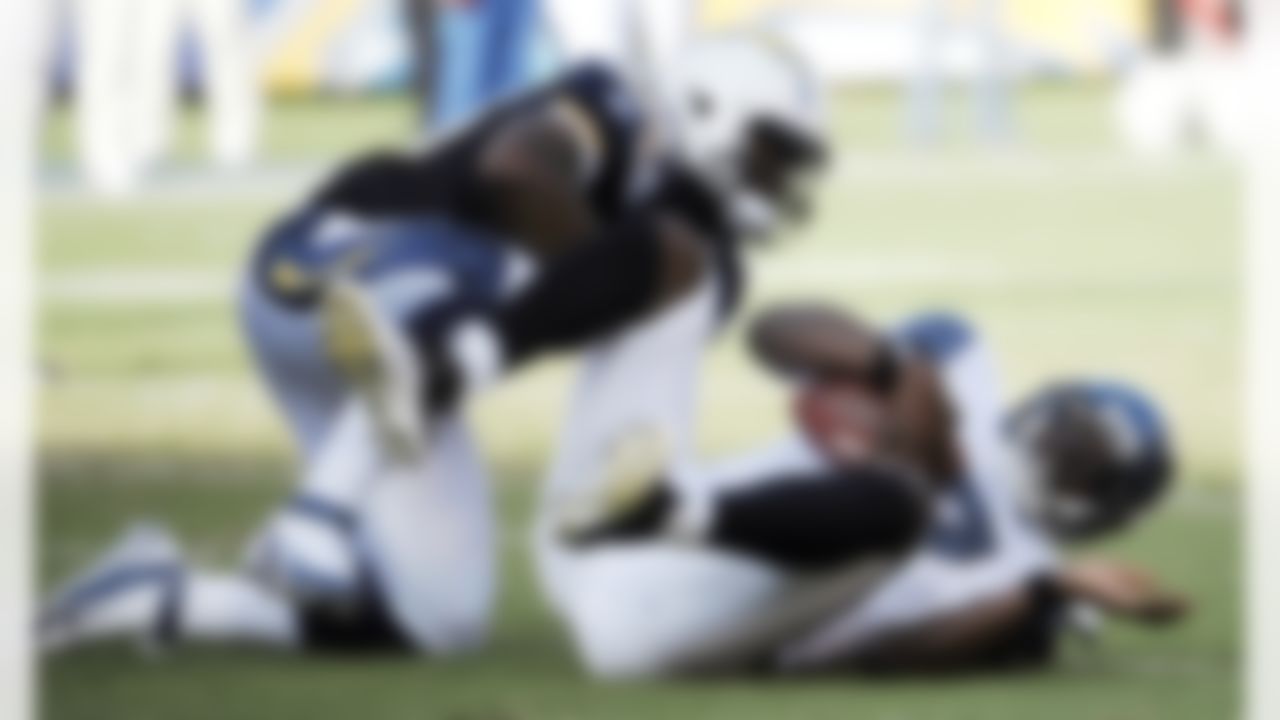 Seattle Seahawks quarterback Tarvaris Jackson, right, lies on the field after being sacked by San Diego Chargers linebacker Darryl Gamble during the first half of their preseason NFL football game at Qualcomm Stadium, Thursday, Aug. 11, 2011, in San Diego. (AP Photo/Denis Poroy)