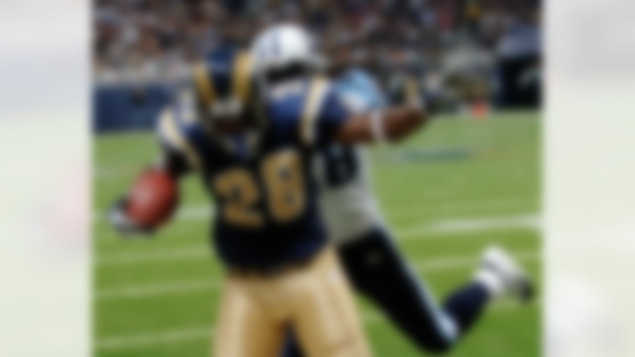 St. Louis Rams' Marshall Faulk (28) runs for a touchdown in the second quarter in front of Tennessee Titans' Lamont Thompson, Sunday, September 25, 2005, in St. Louis. (AP Photo/Bill Boyce)