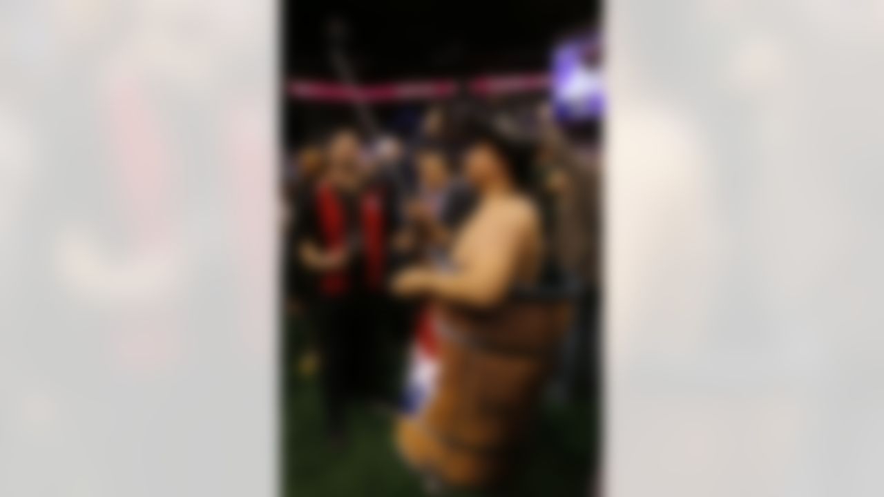 A radio station reporter, wearing a barrel, takes selfies during media day for NFL Super Bowl XLIX football game Tuesday, Jan. 27, 2015, in Phoenix. (AP Photo/Matt York)