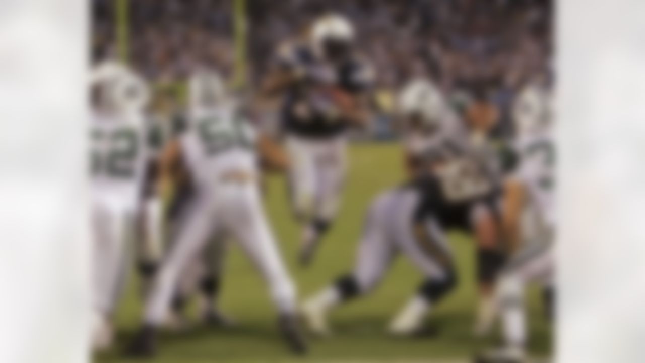 San Diego Chargers running back LaDainian Tomlinson splits the New York Jets defense for a 2-yard touchdown run during the third quarter of an NFL football game Monday, Sept. 22, 2008, in San Diego. The Chargers won 48-29. (AP Photo/Lenny Ignelzi)