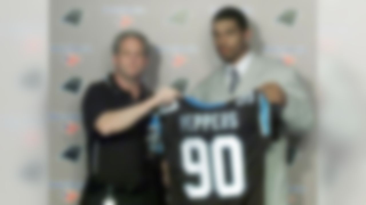 Carolina Panthers coach John Fox, left, helps draft choice Julius Peppers of North Carolina hold up a jersey during a news conference in Charlotte, N.C., Saturday, April 20, 2002, after Peppers was chosen by the Panthers with the second pick of the NFL draft. (AP Photo/Rick Havner)