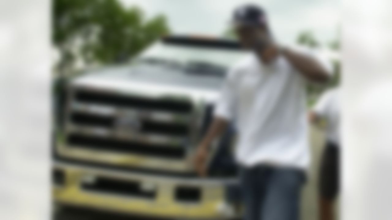 Pittsburgh Steelers wide receiver Plaxico Burress walks in front of his custom pickup truck after arriving at the team's training camp in Latrobe, Pa., on Friday, July 30, 2004. Burress didn't show at the team's coaching meetings earlier in the year. (AP Photo/Keith Srakocic)
