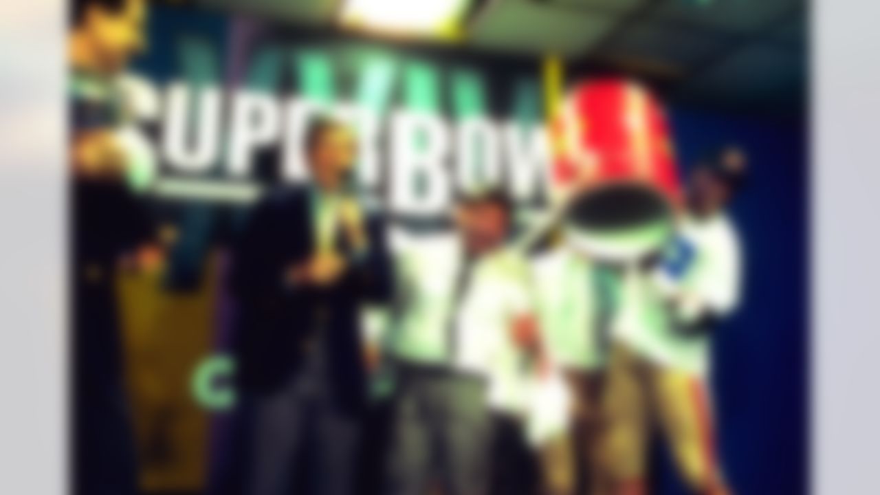San Francisco 49'er owner Ed DeBartolo Jr. is drenched by Eric Wright as Commissioner Paul Tagliabue (with Lombardi Trophy) and CBS' Brent Musburger look on following Super Bowl XXIV in New Orleans on January 28, 1990. (AP Photo/Al Messerschmidt)