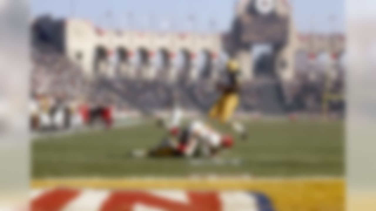 Green Bay Packers Hall of Fame safety Willie Wood (24) leaps over fallen players during Super Bowl I on January 15, 1967, at the Los Angeles Memorial Coliseum in Los Angeles, California. (National Football League)