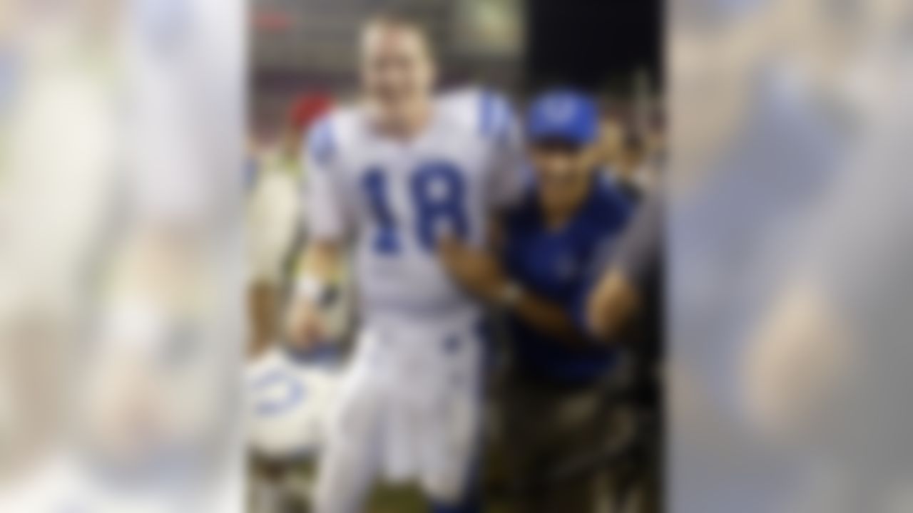 Indianapolis Colts head coach Tony Dungy, right, hugs Colts quarterback Peyton Manning, left, following the teams 38-35 overtime win against the Tampa Bay Buccaneers early Tuesday, Oct. 7, 2003 in Tampa, Fla. (AP Photo/Scott Audette)