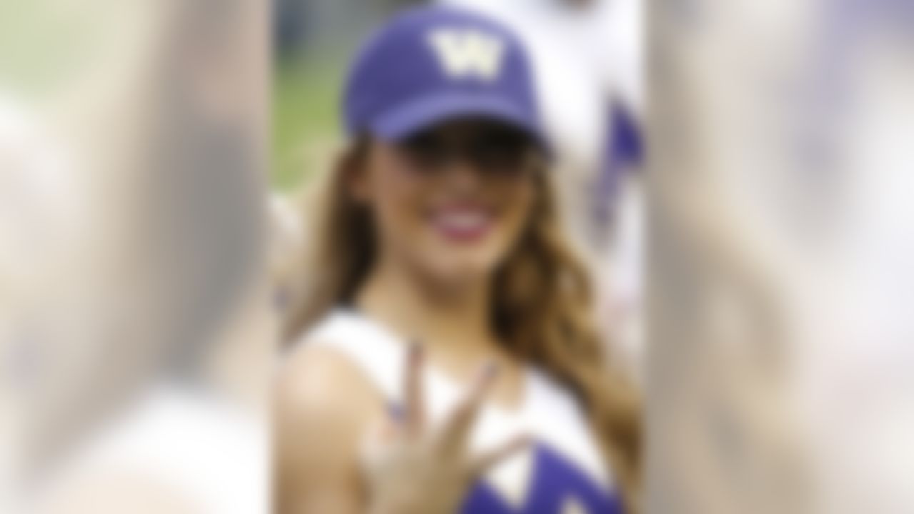 A Washington cheerleader smiles on the sidelines as Washington takes on Southern Mississippi during the second half of the Heart of Dallas Bowl NCAA college football game, Saturday, Dec. 26, 2015, in Dallas. Washington won 44-31. (AP Photo/Ron Jenkins)