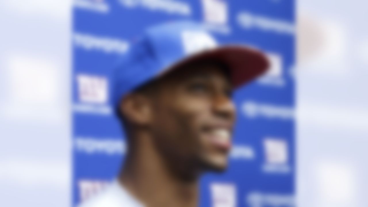 New York Giants wide receiver Victor Cruz smiles as he speaks to reporters at the New York Giants NFL football training camp in Albany, N.Y., Saturday, July 28, 2012. (AP Photo/Kathy Willens)