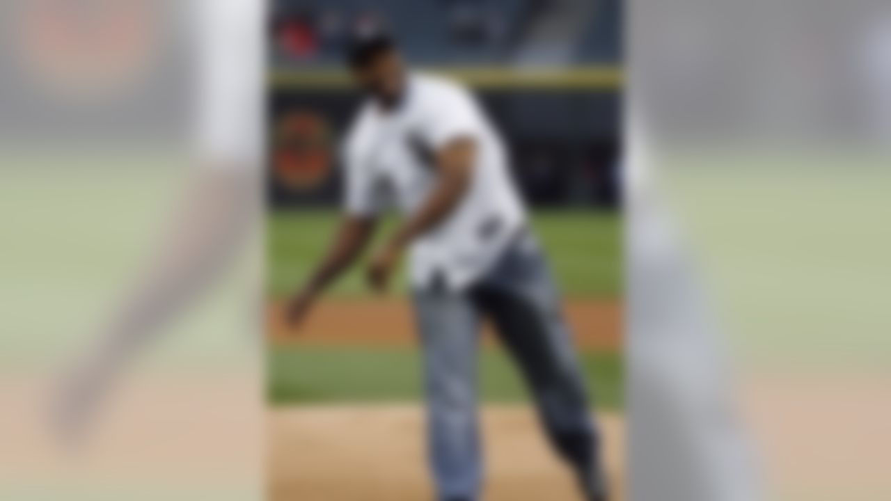 Chicago Bears running back Michael Bush smiles after throwing out the ceremonial first pitch before the Chicago White Sox played the Los Angeles Angels in a baseball game in Chicago on Friday, May 10, 2013. (AP Photo/Charles Cherney)