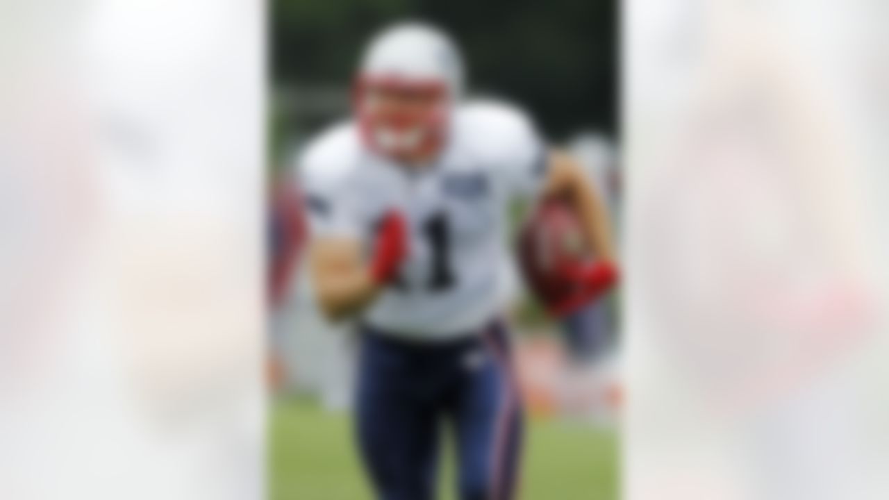 New England Patriots wide receiver Julian Edelman (11) runs with the ball during an NFL football training camp in Foxborough, Mass., Sunday, July 29, 2012. (AP Photo/Steven Senne)