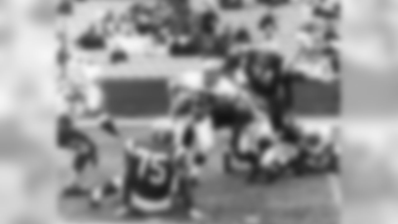 Green Bay Packers quarterback Bart Starr (15) of the Western Conference team is surrounded by opposing team members and is about to be tossed for a 15-yard loss in Pro Bowl game in Los Angeles, Calif., on Jan. 22, 1967. Defenders include tackle Bob Lilly (74) of the Dallas Cowboys and Ben McGee (75) of the Pittsburgh Steelers. (Associated Press)