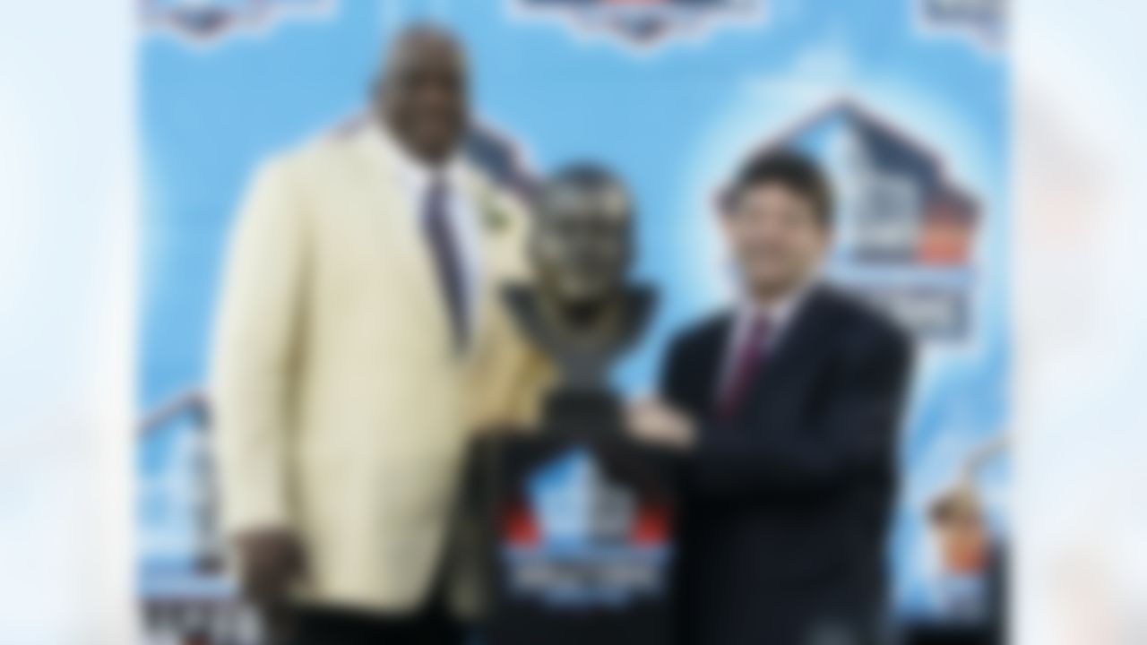 Former San Diego Chargers defensive end Fred Dean stands next to his bronze bust with former San Francisco 49ers owner Eddie DeBartolo at the Pro Football Hall of Fame on Saturday, Aug. 2, 2008. in Canton, Ohio. (AP Photo/Kiichiro Sato)