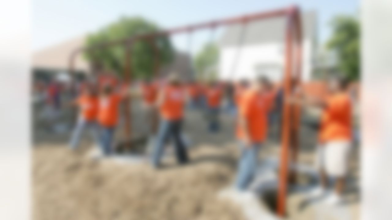 The Home Depot associates working on the playground�s new swing set. (Photo by Alan Marler/CIA Stock Photography, Inc.)
