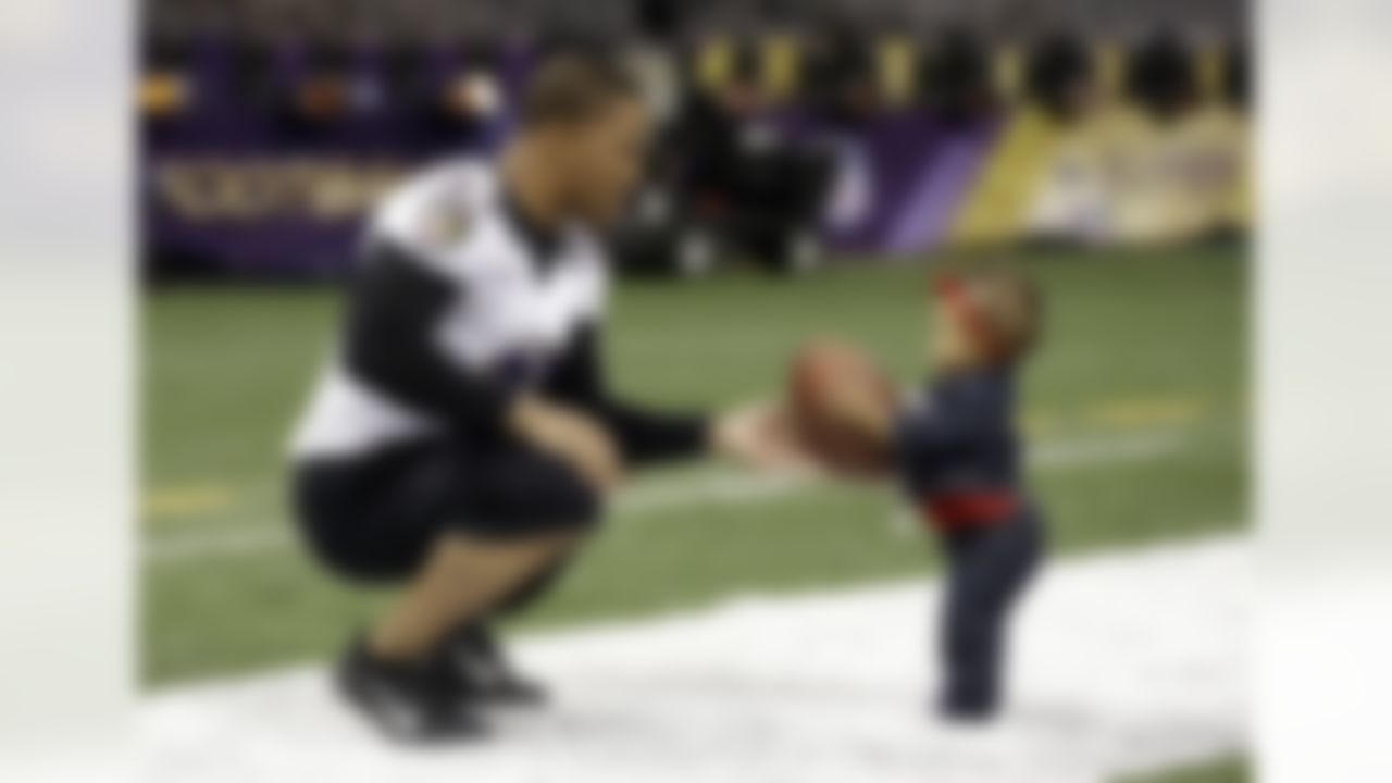 Baltimore Ravens running back Ray Rice, left, hands a football to his daughter, Rayven, age 1, after an NFL Super Bowl XLVII walkthrough on Saturday, Feb. 2, 2013, in the Mercedes-Benz Superdome in New Orleans. The Ravens face the San Francisco 49ers in Super Bowl XLVII on Sunday. (AP Photo/Patrick Semansky)