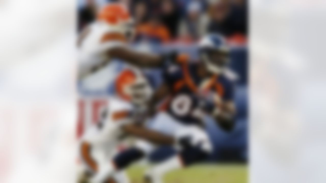 Denver Broncos tight end Shannon Sharpe (84) is pulled down by Cleveland Broncos defenders Michael Jameson (22) and Andra Davis (54) after a 16-yard reception during the third quarter in Denver on Sunday, Dec. 14, 2003. The catch put Sharpe over the 10,000-yard mark for his career. (AP Photo/David Zalubowski)