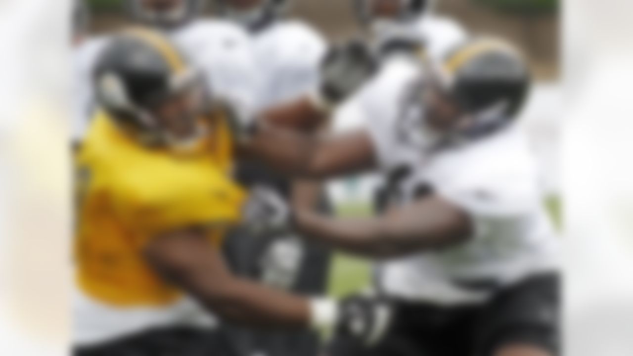 Pittsburgh Steelers tackle Kelvin Beachum, right, tangles with defensive end Ikponmwosa Igbinosun (69) in a blocking drill during practice at the NFL football team's training camp in Latrobe, Pa., on Saturday, July 28, 2012. (AP Photo/Keith Srakocic)