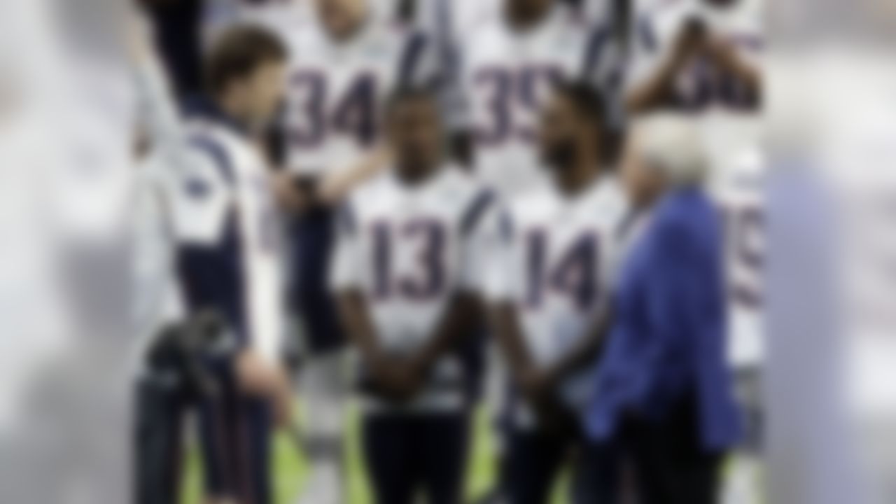 New England Patriots owner Robert Kraft, right, talks with quarterback Tom Brady (12), wide receiver Phillip Dorsett (13) and wide receiver Brandin Cooks (14) before the team photo is made at U.S. Bank Stadium Saturday, Feb. 3, 2018, in Minneapolis. The Patriots are scheduled to face the Philadelphia Eagles in the NFL Super Bowl 52 football game Sunday, Feb. 4.