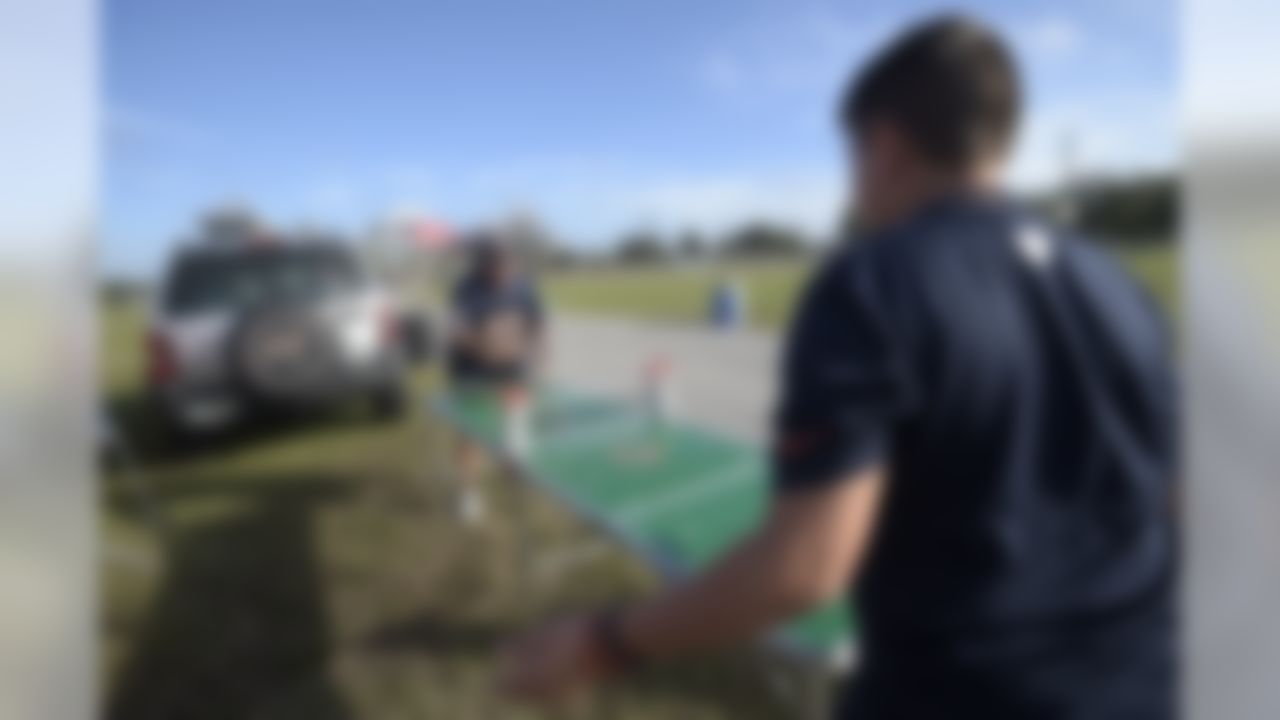 Martin Casillas, left, and his grandson Aaron Casillas play on a ping-pong table while tailgating before an NFL football game between the Chicago Bears and Tampa Bay Buccaneers in Tampa, Fla., Sunday, Dec. 27, 2015. (AP Photo/Phelan M. Ebenhack)