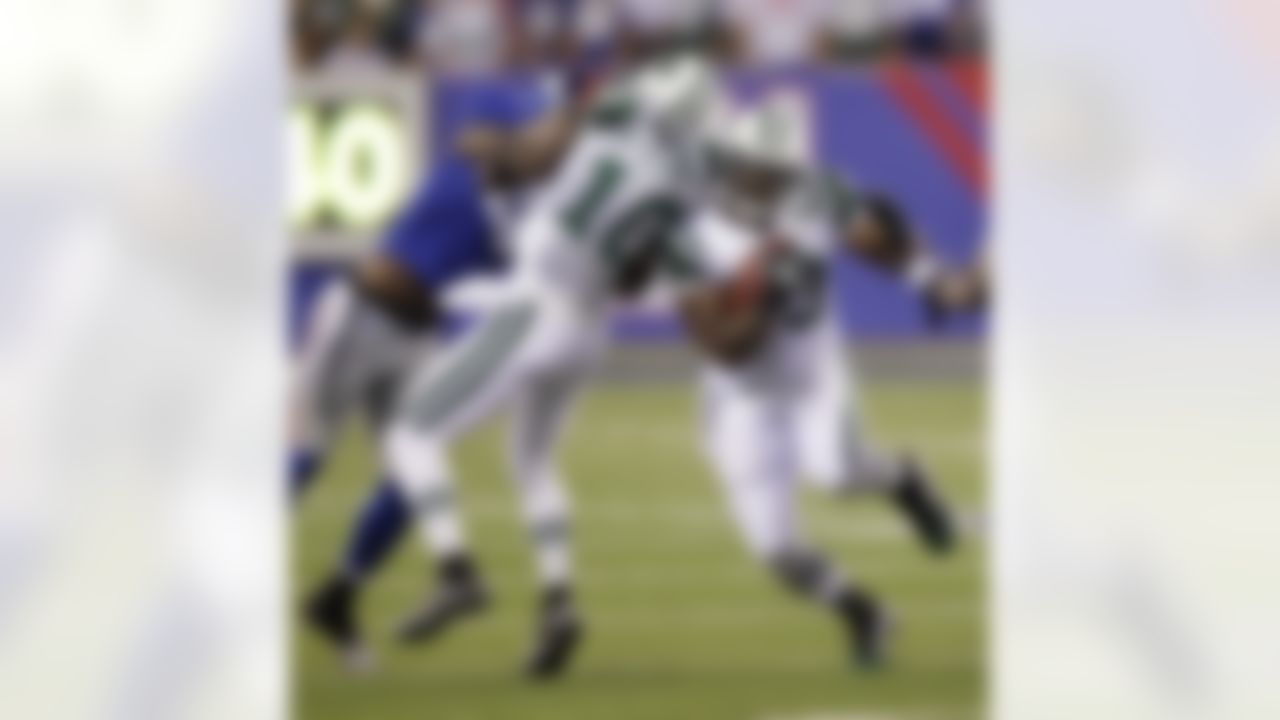 New York Jets' Shonn Greene runs the ball while teammate Santonio Holmes, center, blocks New York Giants' Antrel Rolle during the second quarter of an NFL preseason football game Monday, Aug. 29, 2011, in East Rutherford, N.J. (AP Photo/Julio Cortez)