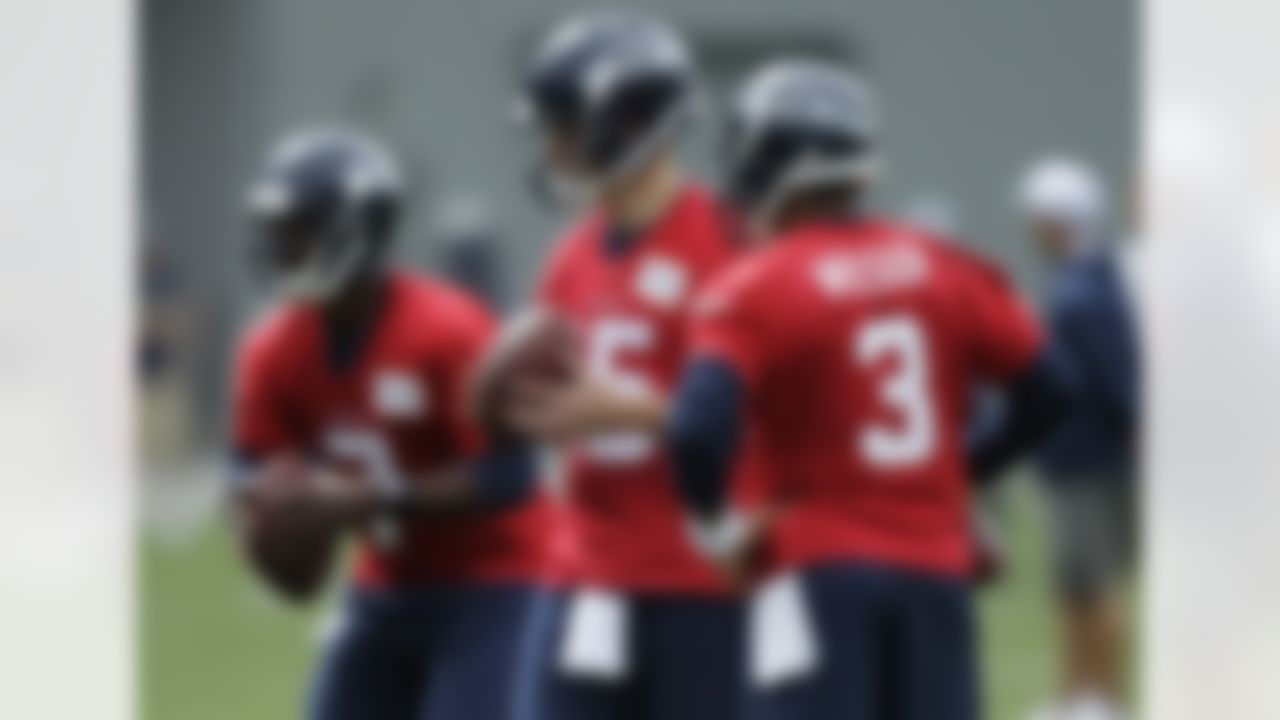 Seattle Seahawks quarterbacks Tavaris Jackson, left, Matt Flynn, center, and Russell Wilson, right, stand together on Saturday, July 28, 2012, on the first day of NFL football training camp in Renton, Wash. (AP Photo/Ted S. Warren)