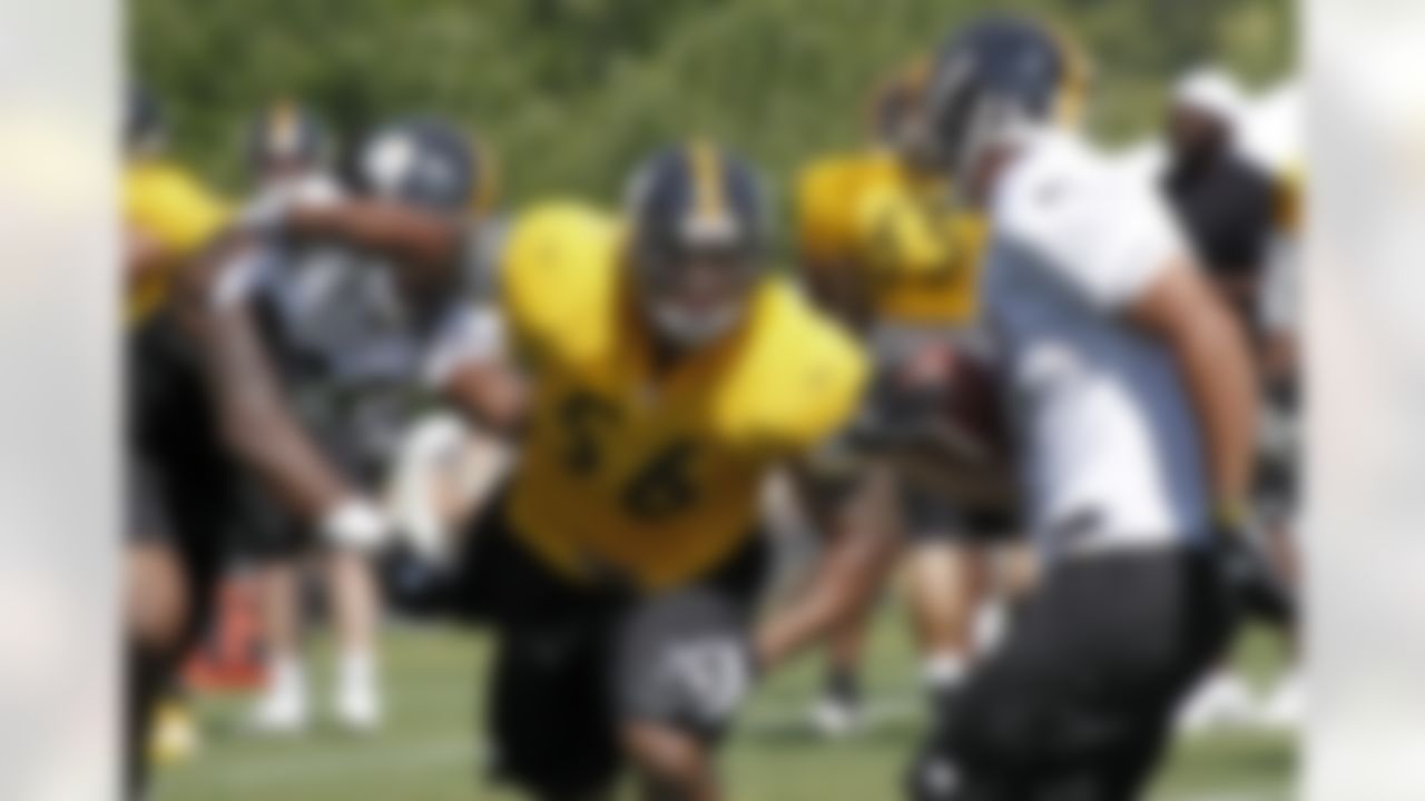 Pittsburgh Steelers linebacker LaMarr Woodley (56) gets past tight end David Johnson, left, during a blocking drill practice at NFL football training camp in Latrobe, Pa., Sunday, July 29, 2012. (AP Photo/Keith Srakocic)