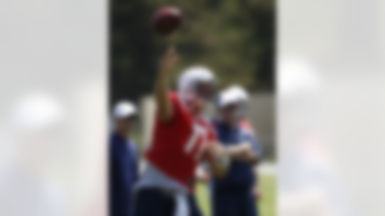 San Diego Chargers quarterback Philip Rivers releases a pass as coach Norv Turner, right, watches during practice at the Chargers' training camp Monday, July 23, 2012 in San Diego. (AP Photo/Lenny Ignelzi)