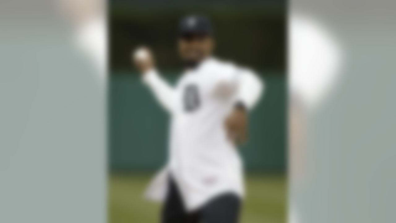 Charles Woodson, former Heisman Trophy winner at the University of Michigan and current Green Bay Packers player, throws a ceremonial first pitch before the Detroit Tigers and theSeattle Mariners baseball game in Detroit, Wednesday, April 27, 2011. (AP Photo/Paul Sancya)