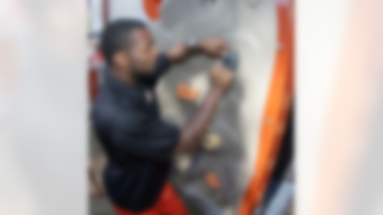 Braylon Edwards puts pieces of the new climbing wall in place. (Photo by Alan Marler/CIA Stock Photography, Inc.)