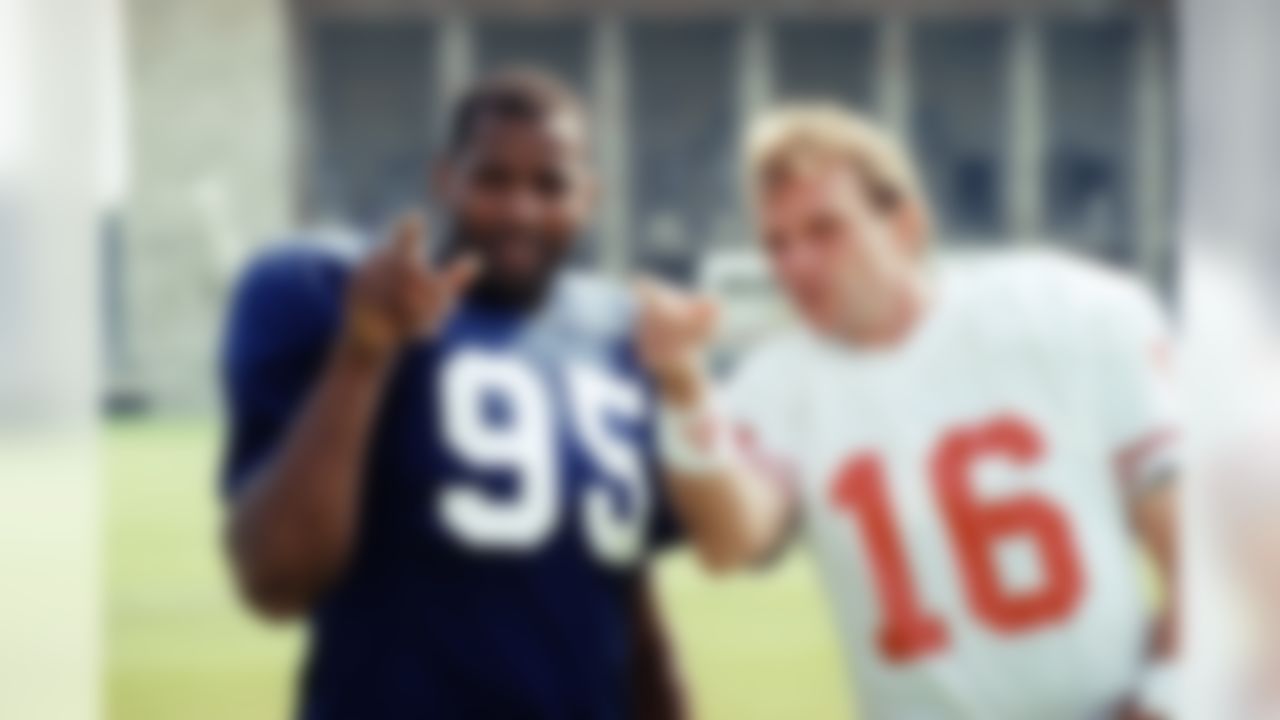 Richard Dent defensive end of the Chicago Bears, left, and San Francisco 49ers quarterback Joe Montana standing together during practice, Thursday, August 1, 1991 in Berlin's Olympic stadium. The two teams will have an exhibition game on Saturday, August 3. (AP Photo/Arna Dedert)