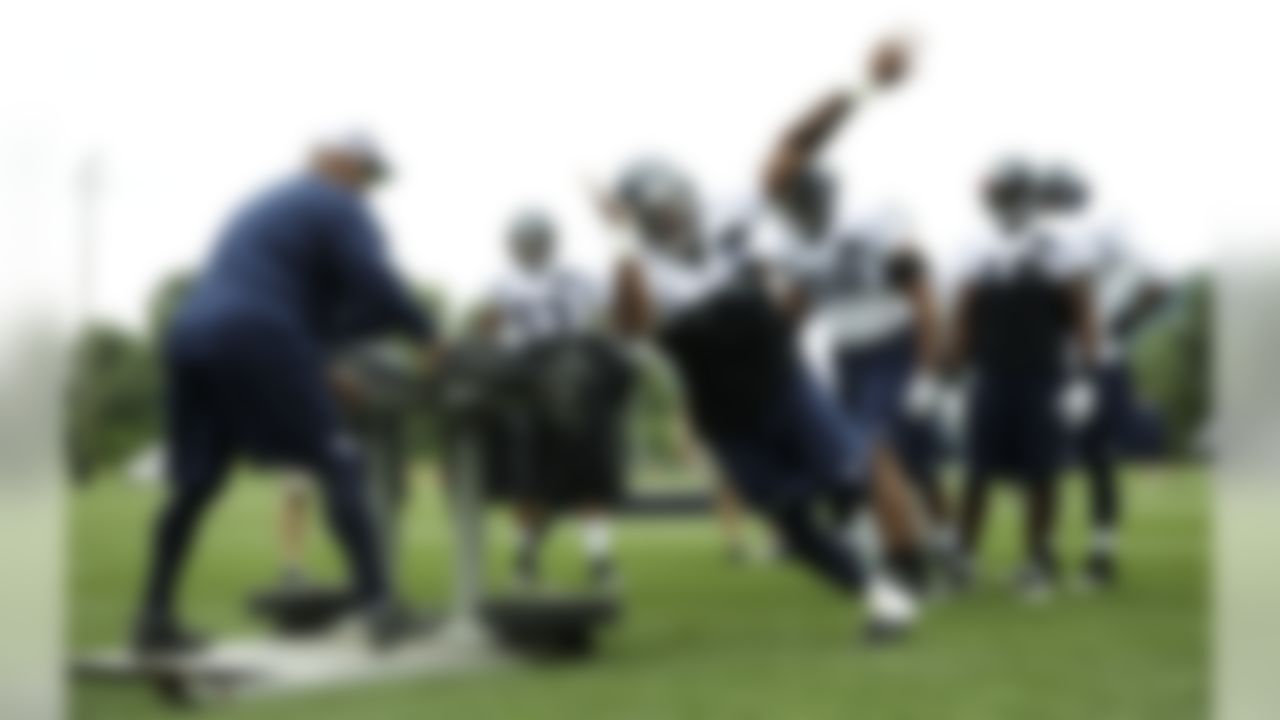 Seattle Seahawks' linebacker LeRoy Hill center, takes part in a blocking drill, Monday, July 30, 2012, at NFL football training camp in Renton, Wash. (AP Photo/Ted S. Warren)