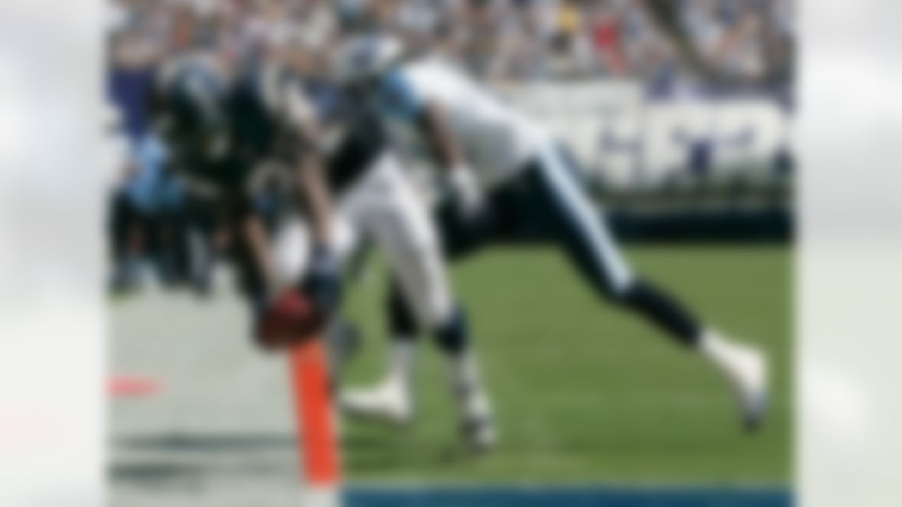 San Diego Chargers' LaDainian Tomlinson scores his second touchdown past Tennessee Titans' Reynaldo Hill during the first half of their NFL football game Sunday, Sept. 17, 2006, in San Diego. (AP Photo/Chris Carlson)